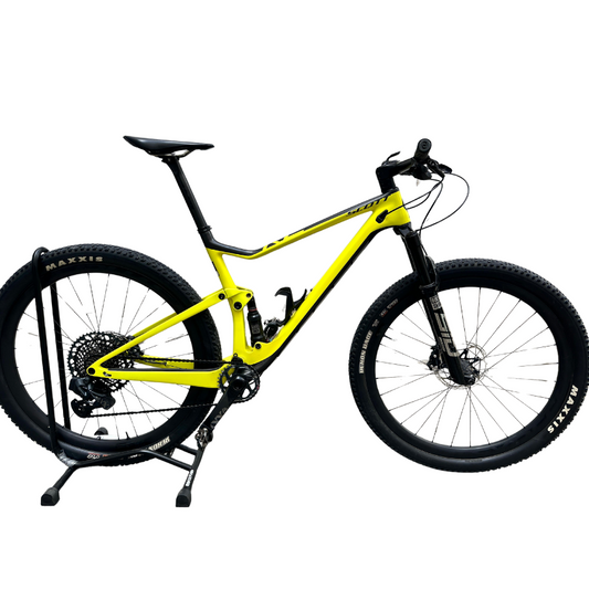 Pre-owned 2021 Scott Spark RC World Cup full suspension carbon mountain bike showing lightweight hmx frame yellow paint finish rockshox sid fork rockshox nude rear shock twinloc handlebar remote syncros fraser ic sl integrated cockpit and upgraded sram gx eagle axs wireless electronic transmission - Epic Sports Kenya
